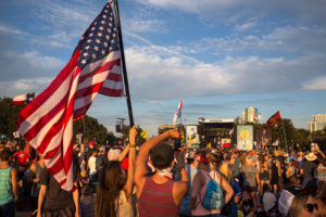 Olivia Stout holds up an American flag while her boyrfriend, Dylan Ionnotti, snaps a photo of Willie Nelson performing on the final day of the second weekend of the 2016 Austin City Limits Festival at Zilker Park Oct. 9. 10/09/16 Tom McCarthy Jr. for AMERICAN-STATESMAN